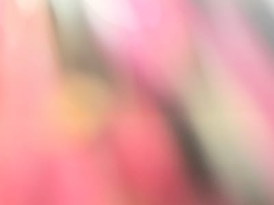 The image is an abstract, out-of-focus depiction of soft colors, primarily shades of pink, peach, and light green, with some areas appearing almost white or grayish. Diagonal lines and blurs suggest movement or a textured surface. There are no discernible people, objects, or specific environmental details that would place it in Lafiagi, Nigeria, or any other identifiable location. The image is purely abstract and lacks any concrete representational elements.