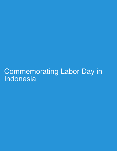 The image features a minimalist design with a solid, vibrant blue background. The primary subject is white text, positioned in the lower-left quadrant of the frame. The text reads: "Commemorating Labor Day in Indonesia." There are no visible people or objects beyond this text. The scene is devoid of specific environmental details, implying a digital graphic or slide rather than a photograph of a physical setting.

The event taking place is the commemoration of Labor Day in Indonesia, as explicitly stated by the text. This suggests the image is likely a title card, a banner, or an informational graphic introducing content related to this event. Given the location context of Tebel, Indonesia, the content that this graphic accompanies would pertain to Labor Day observations in that specific area or within the broader Indonesian context.

Notable details include the clear, sans-serif font of the white text, which stands out against the blue background. There are no indications of the time of day, weather conditions, or specific emotions conveyed by the visual elements, beyond the informational nature of the text.