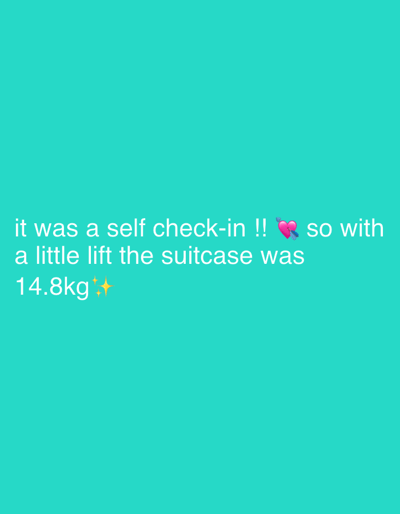The image displays white text superimposed on a solid teal-green background, indicating a past event related to travel. The text reads: "it was a self check-in !! 💘 so with a little lift the suitcase was 14.8kg✨". An arrowed heart emoji (💘) follows "check-in," and a sparkle emoji (✨) concludes the description after "14.8kg." The content implies an individual successfully weighed their suitcase at a self-service check-in station, with the suitcase registering 14.8 kilograms, presumably at Stockholm-Arlanda Airport in Sweden. No people, objects other than text and emojis, or specific environmental details of the airport are visually present.