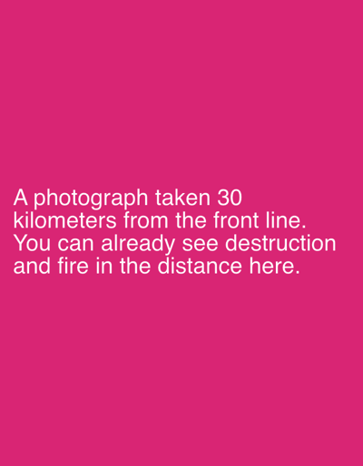 The image displays a solid, uniform magenta background. White, sans-serif text is centrally aligned in the lower portion of the image. The text reads: "A photograph taken 30 kilometers from the front line. You can already see destruction and fire in the distance here." No people, discernible objects, actions, or specific environmental features are depicted within the image itself beyond the colored background and the textual content. The text refers to an implied scene located 30 kilometers from a front line, a geographical context associated with the region surrounding the city of Izium, Ukraine.