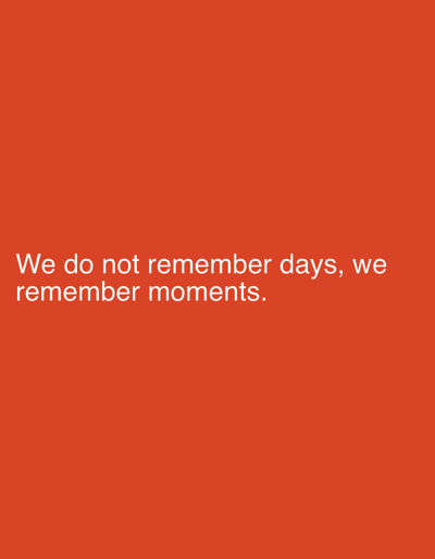 The image contains white text on a solid orange background. The text reads: "We do not remember days, we remember moments." There are no people, subjects, objects, actions, or interactions depicted in the image. The background appears to be a plain, uniform color, with no discernible environmental features or urban context, and therefore no specific location in Рудзенскі сельскі Савет, Belarus can be determined.