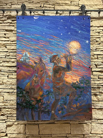 A vibrant, large-scale painting is displayed on a stone wall, mounted with industrial-style black hardware. The painting depicts a colorful, abstract night sky with streaks of blue, orange, and yellow, dotted with stars and celestial bodies. In the foreground, a man in a hat and simple clothing is looking through a telescope-like object towards the sky. To his left, a brown horse stands patiently, its head turned slightly towards the viewer. In the background, on a hill, a white building with domes, resembling an observatory, is visible. The painting utilizes bold brushstrokes and a striking color palette to create a dreamlike and atmospheric scene. The stone wall, composed of roughly cut light-colored stones, provides a rustic and textured backdrop to the artwork. The scene is illuminated by artificial lighting, casting subtle shadows. The bottom right corner of the painting shows a signature, possibly "A. Holme."