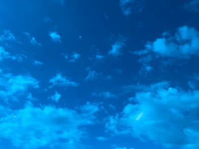 The image shows a blue sky with scattered white clouds. There is no evidence to indicate this image was taken in Tlustenkhabl, Russia. No people, actions, or interactions are depicted.