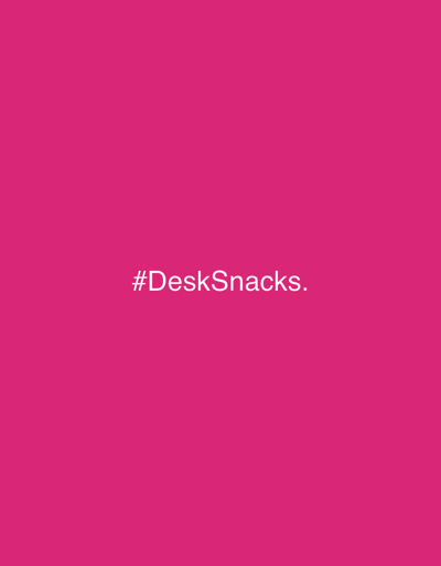 The image is a solid, uniform pink background with the text "#DeskSnacks." centered in white. The setting is not specified and there are no indications it is located in Amangwu, Nigeria or any other specific location. There are no people, subjects, objects, actions, or interactions present in the image, other than the text.