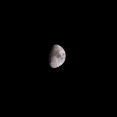 The image shows a crescent moon against a black sky. The moon is partially illuminated, with the right side of the moon appearing brighter than the left. The surface of the moon is visible, with some craters and darker patches that suggest lunar features. The image is taken from a low vantage point, as the moon appears to be high in the sky. There are no people, objects, or other environmental details visible in the image, other than the moon and the sky. The image is devoid of any context that would allow for the determination of its location in Illescas, Spain.