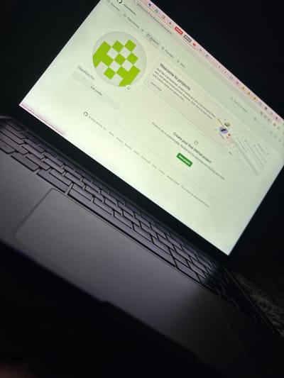 The image shows a laptop screen displaying a GitHub profile page. The profile belongs to "EliasWaicho" and is currently viewing the "Projects" tab. The page welcomes the user to projects, suggesting it as a flexible tool for planning and tracking work. It also prompts the user to create their first GitHub project with a "New project" button. The laptop keyboard and trackpad are visible in the foreground, partially obscured by darkness. The URL "github.com/EliasWaicho/projects" is visible in the browser's address bar, with "EliasWaicho" visible below the GitHub logo.