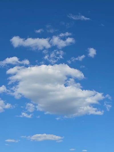 The image depicts a bright blue sky filled with scattered white clouds. The clouds vary in size and density, with some appearing wispy and others more substantial and fluffy. The lighting suggests it is daytime, likely a clear and sunny day. There are no people, buildings, or any other objects visible in the frame, only the expanse of the sky and the clouds within it. The provided location of Bobenheim-Roxheim, Germany, is not visually represented in the image itself.
