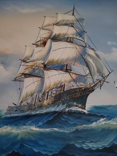 This is a painting of a sailing ship on a stormy sea. The ship has several sails, most of which are billowing in the wind. The water is choppy with large waves and whitecaps. The sky is a mix of blue and white clouds, suggesting overcast or turbulent weather. The overall impression is one of a powerful vessel navigating challenging conditions. There is a small white bird in flight to the right of the ship. The painting appears to be an oil painting.