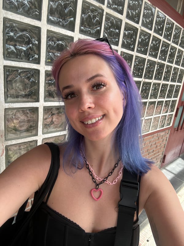 Woman with colorful hair spotted near glass wall in Madrid