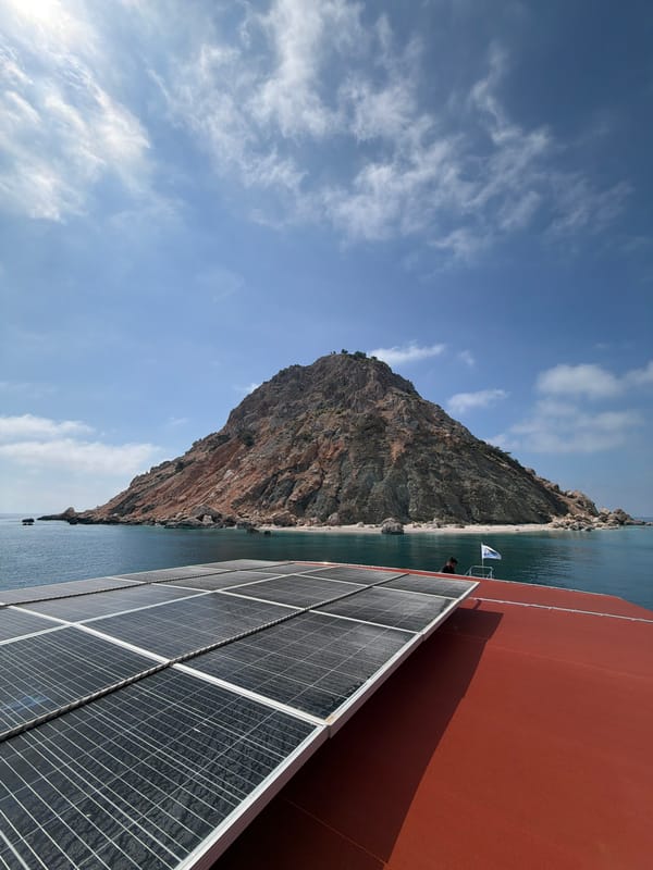 Boat passengers document scenic Turkish coastal cliffs journey