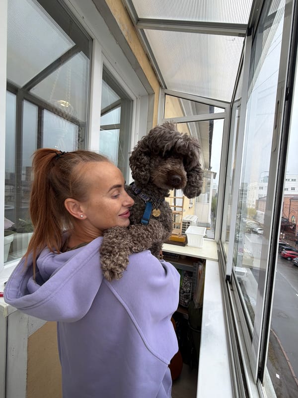 Woman and poodle spend rainy morning in Krasnoyarsk