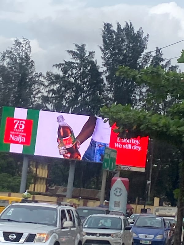 Slow traffic and billboard-lined streets in Ikeja, Lagos