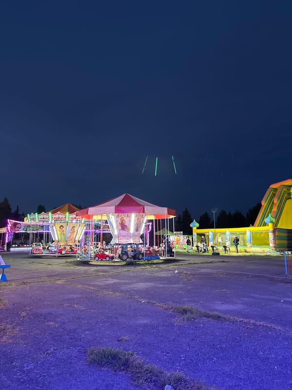 Evening carnival operates in Pomorie, Bulgaria with illuminated rides