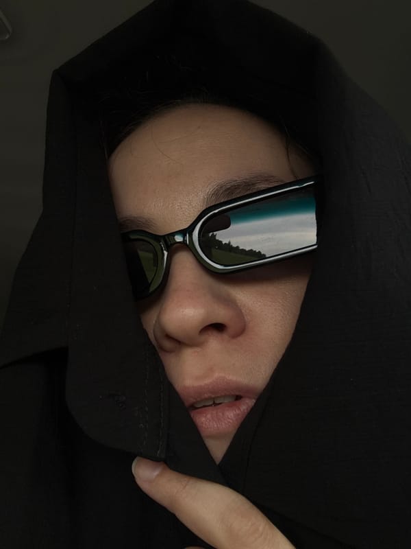 Person in dark attire spotted resting in Russian village