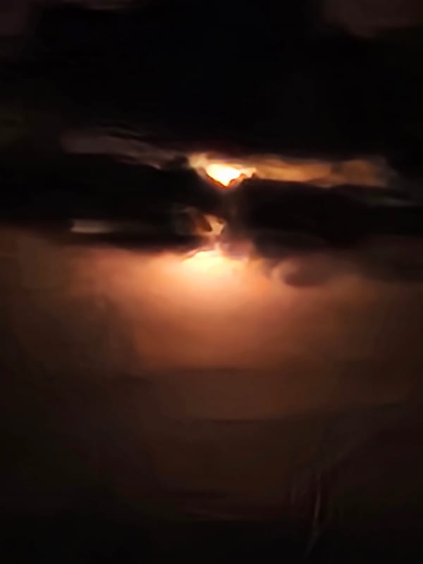 Moon or sun breaks through heavy clouds over Warsaw