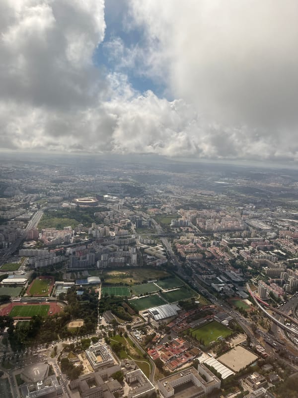 Aerial view captures Lisbon cityscape with stadium, sports facilities