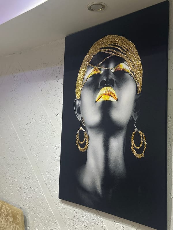 Portrait artwork with gold accents displayed on wall