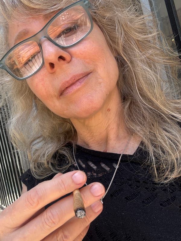 Woman smokes marijuana indoors in Tel Aviv