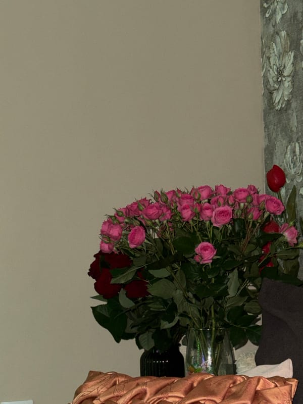 Pink and red rose arrangement observed in transparent vase