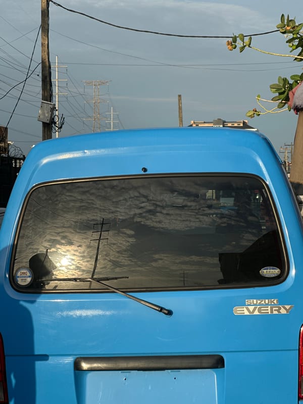 Blue van parked on street in Ilado, Nigeria