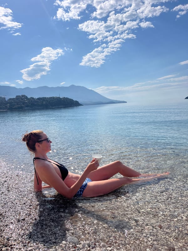 Woman enjoys morning beach moment in Budva, Montenegro