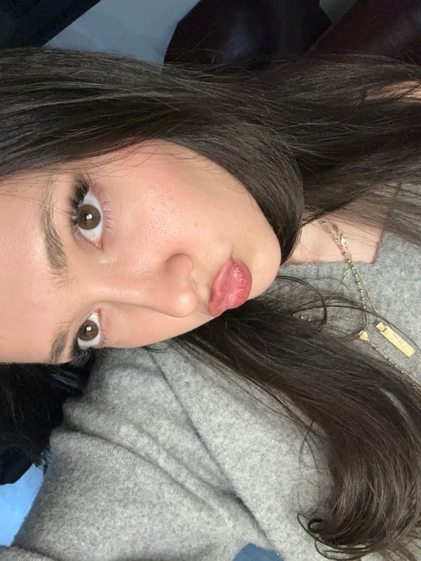 Two women take mirror selfies in Zovuni, Armenia