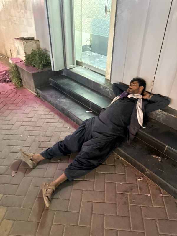 Evening scenes captured in Quetta: resting man, lit storefront