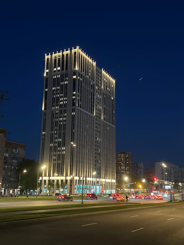 Tall urban building observed illuminated at night