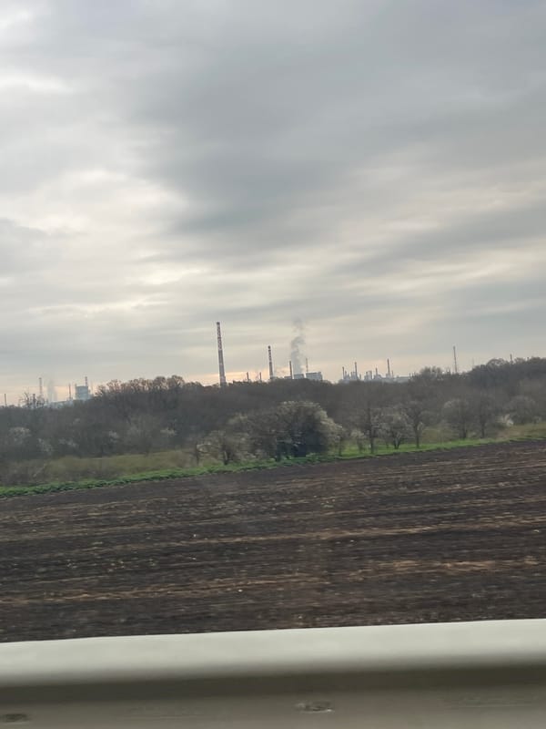 Industrial chimneys visible beyond cultivated fields in Kameno, Bulgaria