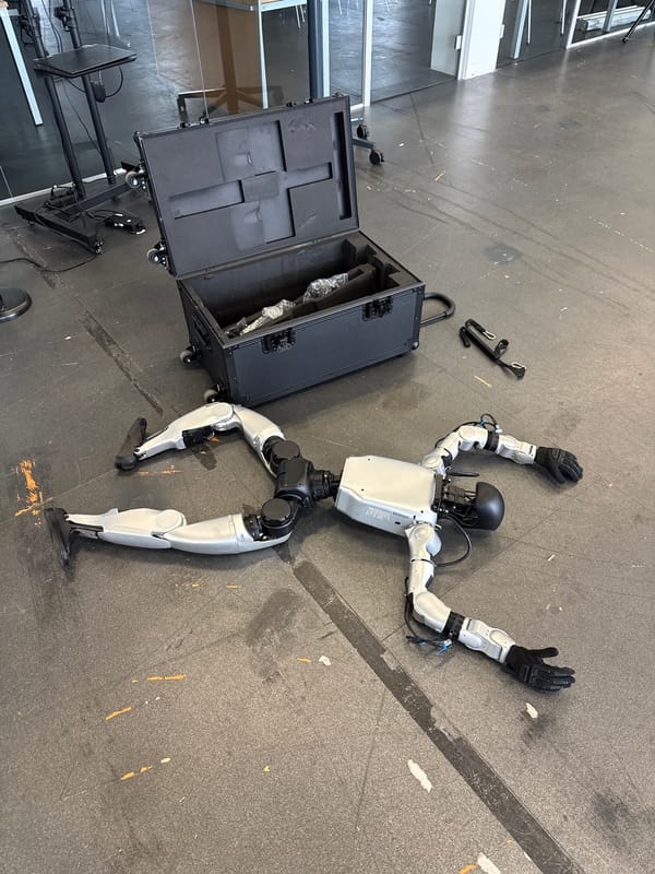 Humanoid robot found motionless on floor, arms splayed