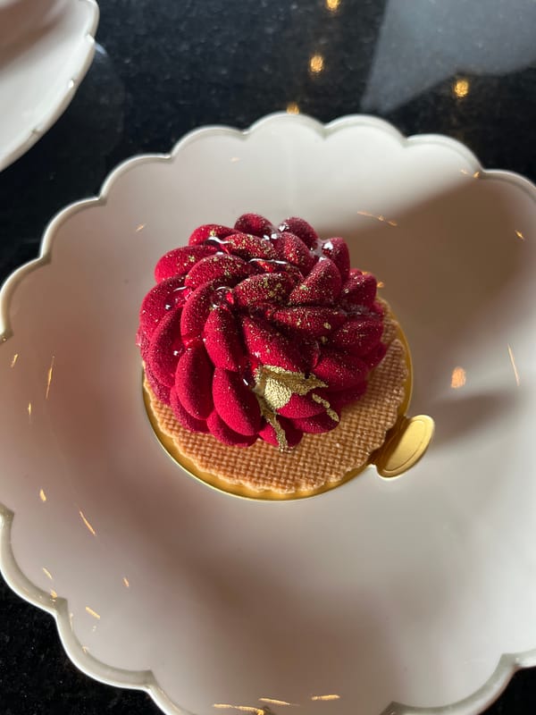 Decorated cake with red flower frosting photographed from above