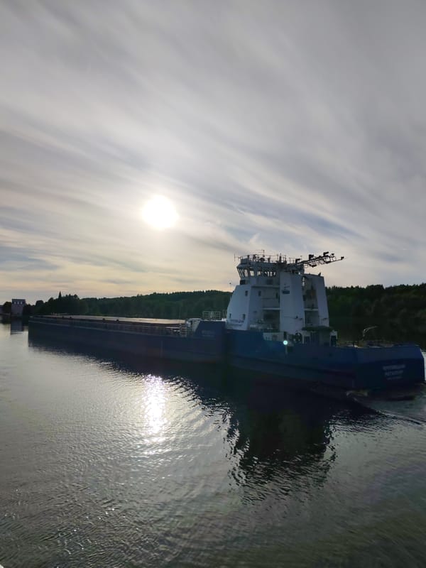 Cargo vessel navigates waterways near Markovo lock system
