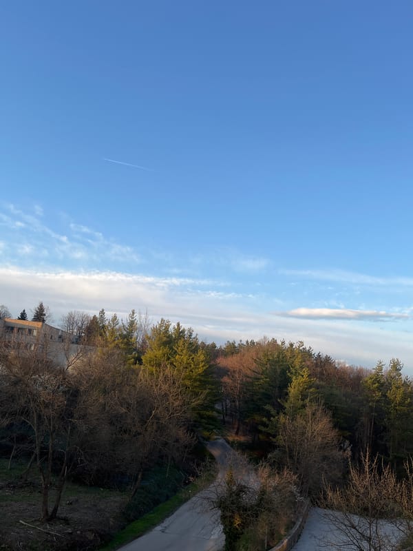Aircraft contrail spotted over Gabrovo, Bulgaria hillside landscape