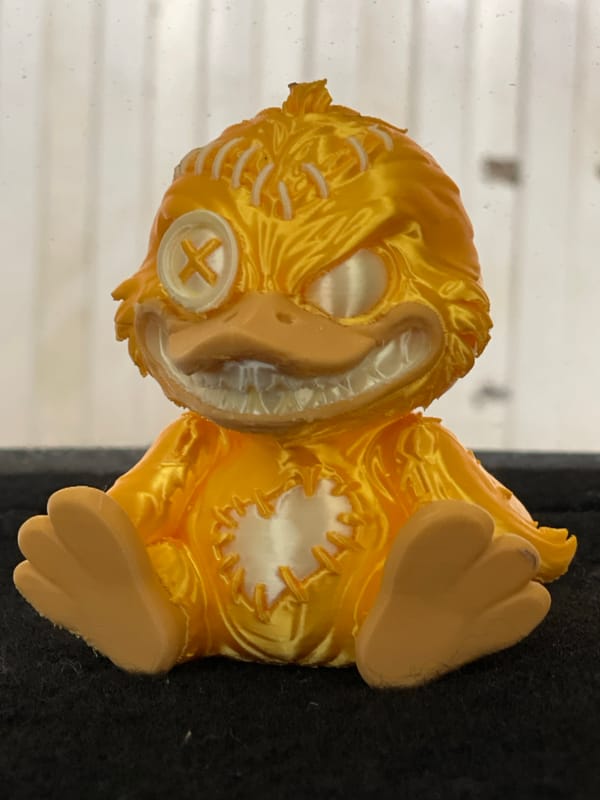 Yellow stitched bird figurine documented in Zelenograd studio shots