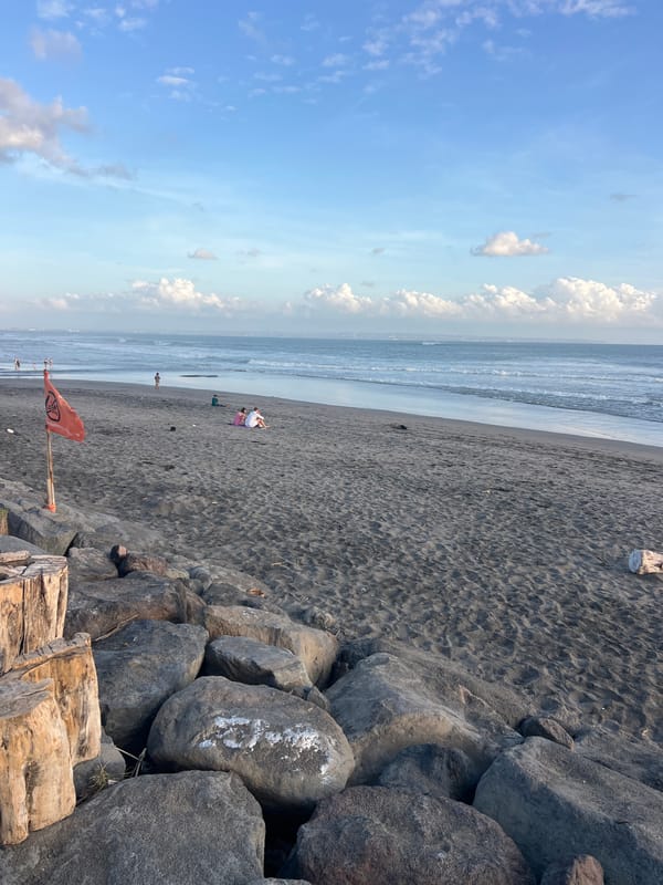 Bali's black sand beach buzzing with activity on a July morning