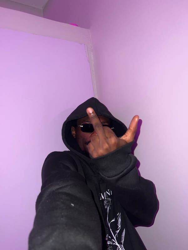 Hooded figure photographed making gestures in Lagos residence