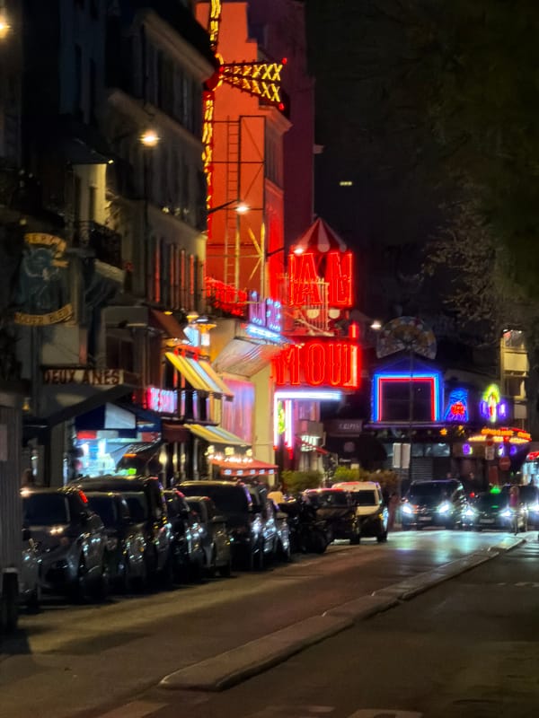 Tourist documents evening visit to Moulin Rouge district