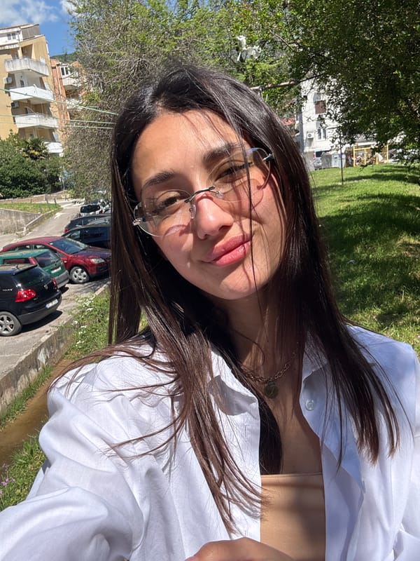 Woman takes selfie on street in Budva, Montenegro