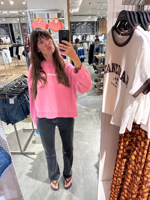 Woman takes selfies in Kuta clothing store