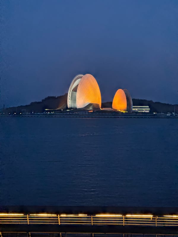 Zhuhai Opera House glows orange in nighttime waterfront display