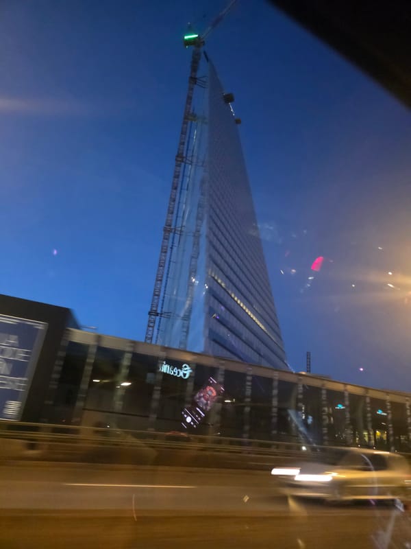 Glass tower rising in Issy-les-Moulineaux under night construction lights