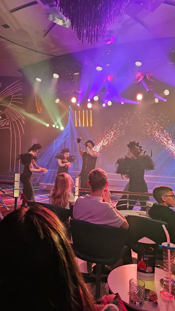 Four performers on a pyrotechnic-lit stage, mid-show.