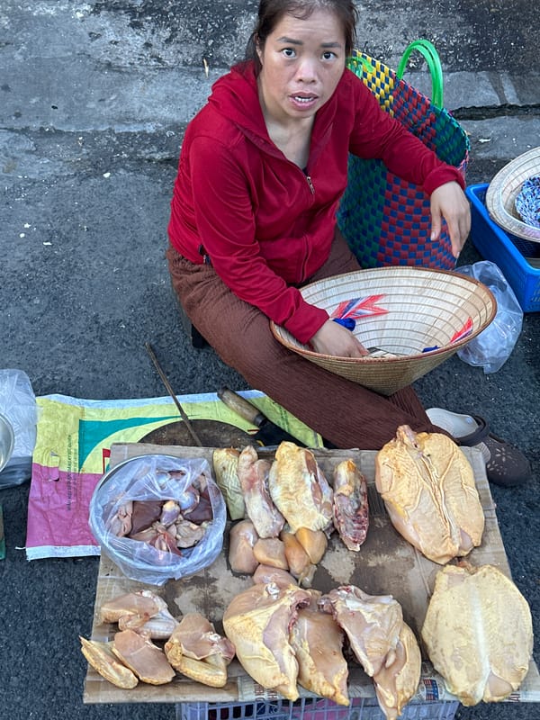 Street market life in Nam Nha Trang, vendors and traffic at dusk
