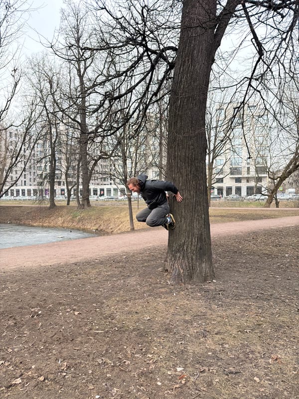 Man poses with golden frame in Saint Petersburg