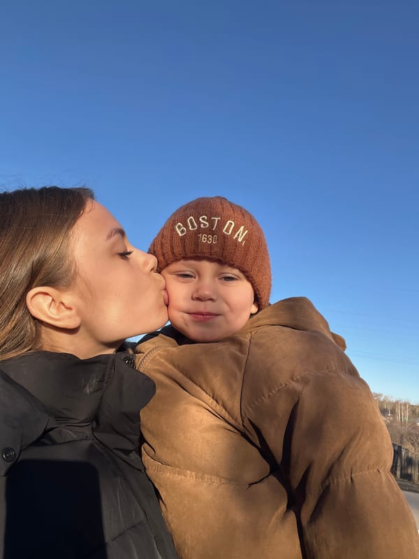 Mother and child enjoy outdoor playtime in Russian village