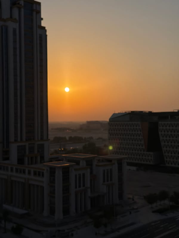 Sunset sweeps across a modern city skyline and streets