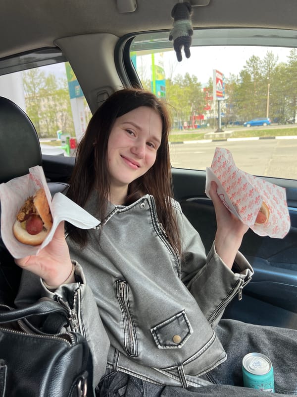 Two women share late-night hot dogs in car