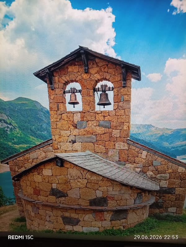 Stone bell tower by a mountain lake in Mykolaivka, Ukraine