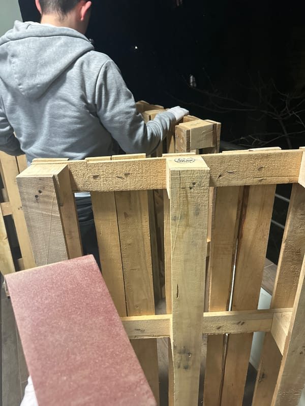 Man works with wood pallets outdoors in Sofia