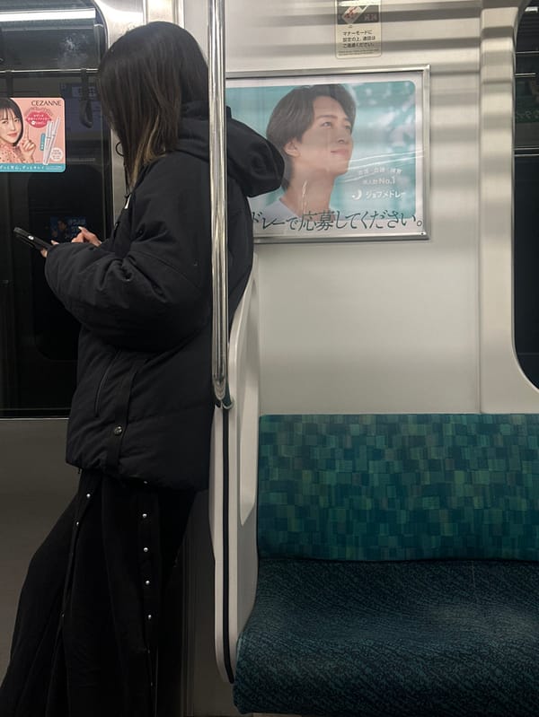 Solitary commuter rides train in Nakano, Japan